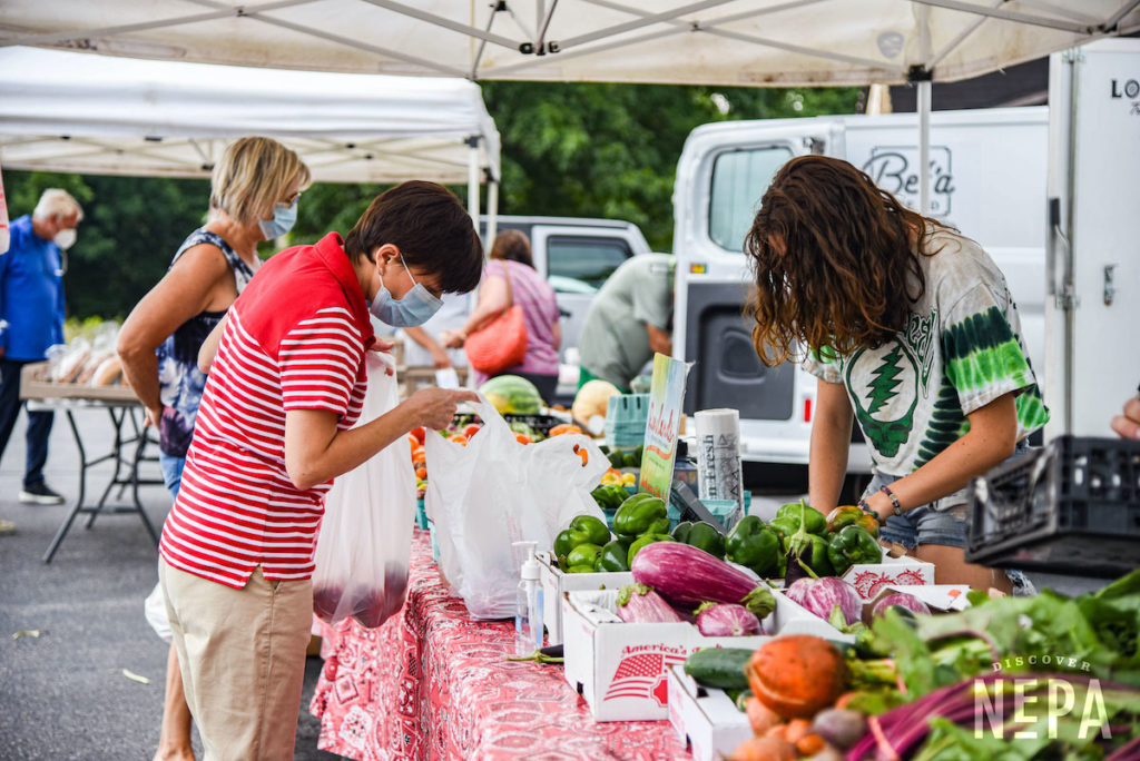 people shopping at a farmers market